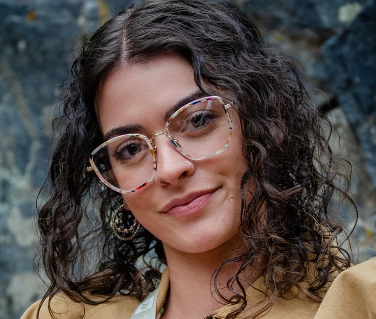 Woman wearing fashionable eyeglass frames, smiling
