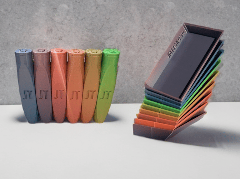 Colorful 3D printed organizing containers and stacked lids with JT logo branding.