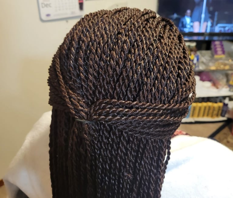 a woman with a large braid braid hair style