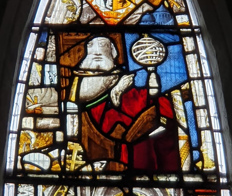 Detail of the East Window at All Saints Church, Landbeach. Figure of a magus with armillary sphere.