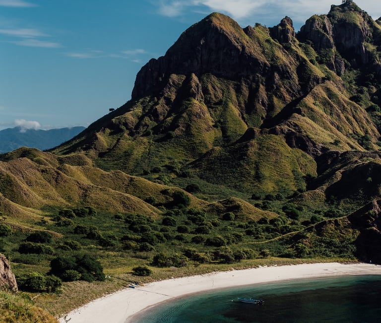 a boat in the water near a mountain