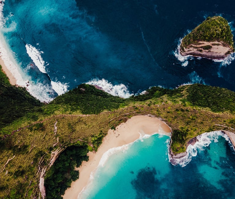 a view of a kelinking beach with a couple of people standing on the beach
