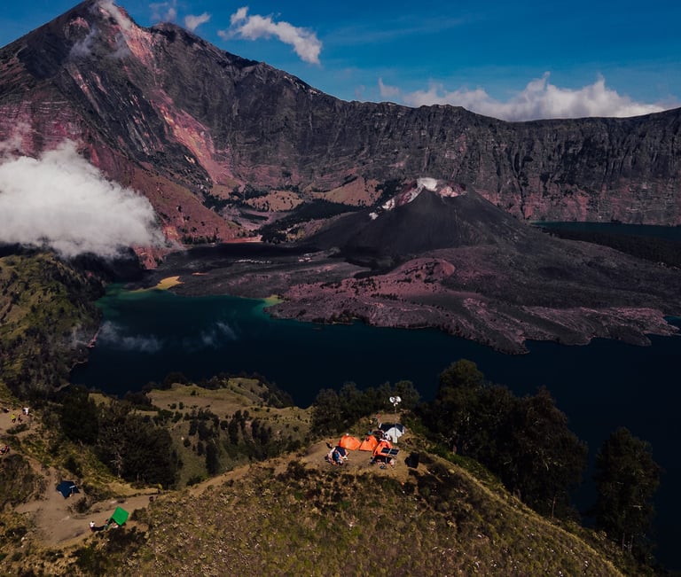 a group of people standing on a mountain top named Rinjani