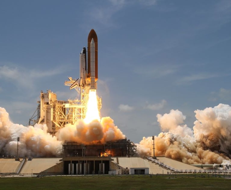 A rocket ship taking off representing fast time to value in saas.