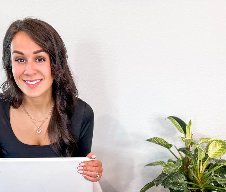 Woman holding laptop and smiling