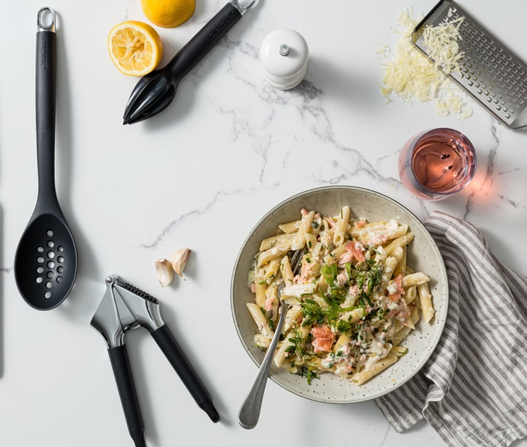 Food product photography - a bowl of pasta with a glass and utensils