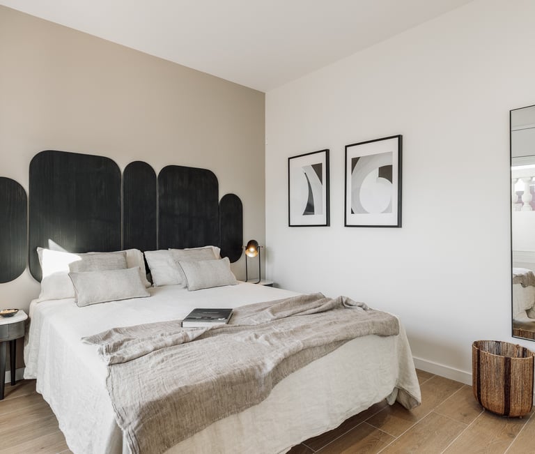 Vibrant bold black wood headboard design in a bedroom with neutral colours and natural materials