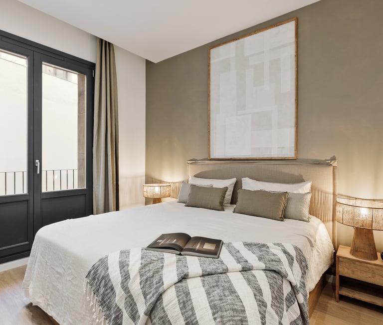 Elegant bedroom with custom artwork and brown and beige colour palette in Barcelona