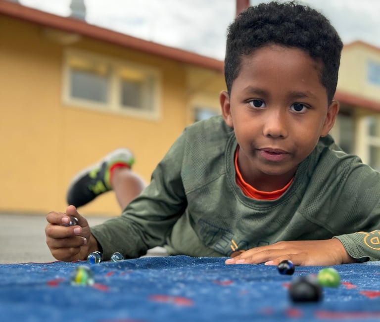 boy playing marbles