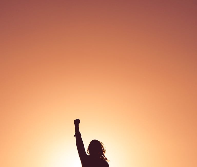 a person standing on a hill watching sunrise