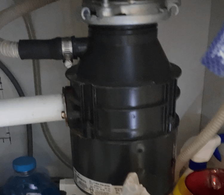 a garbage disposal under a sink in a kitchen