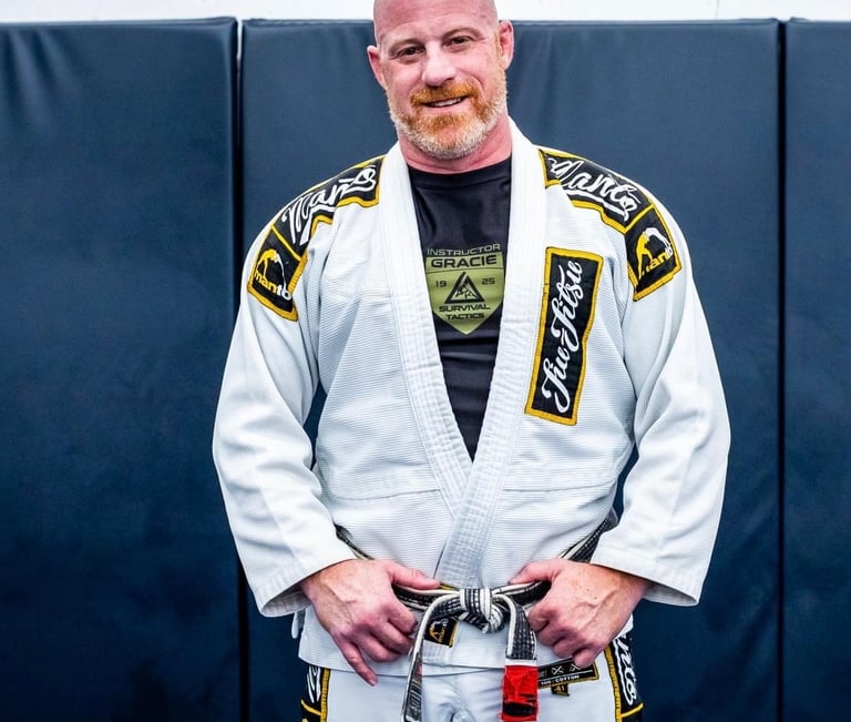 a man in a white gi and bjj black belt