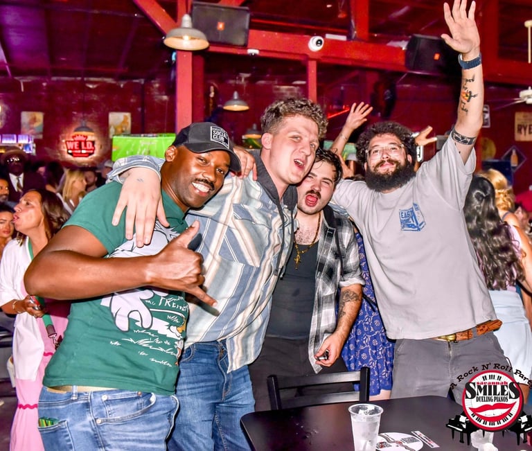 Bachelor party guests singing along during an interactive dueling piano show at Savannah Smiles in S