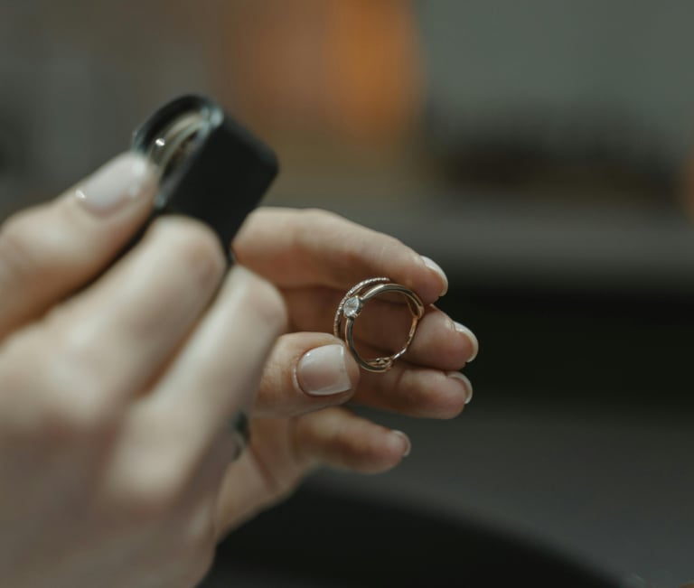 a professional valuer inspecting a diamond ring under a magnifying loupe