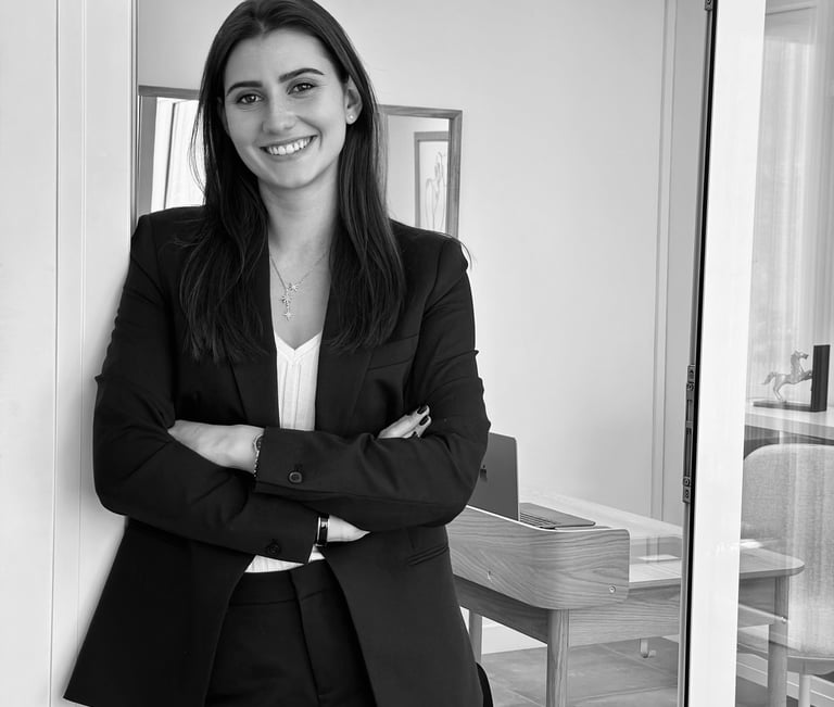 a woman in a suit and tie smiling for the camera