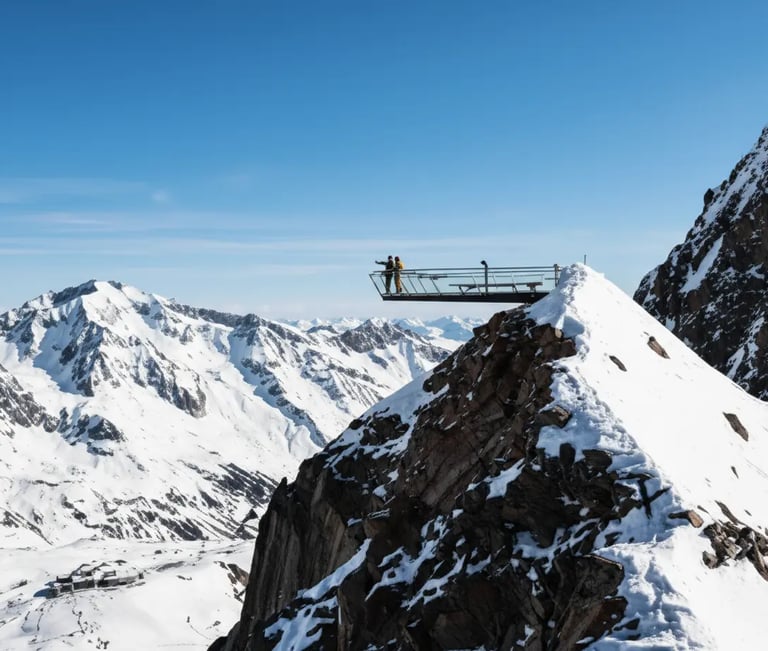 Modern mountain observation deck with panoramic view of snowy Austrian Alps.