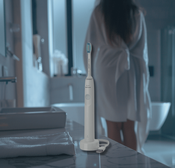 a woman in a robe is standing in front of a sink