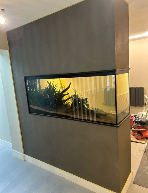 a fish tank with a fish tank in the middle of a room