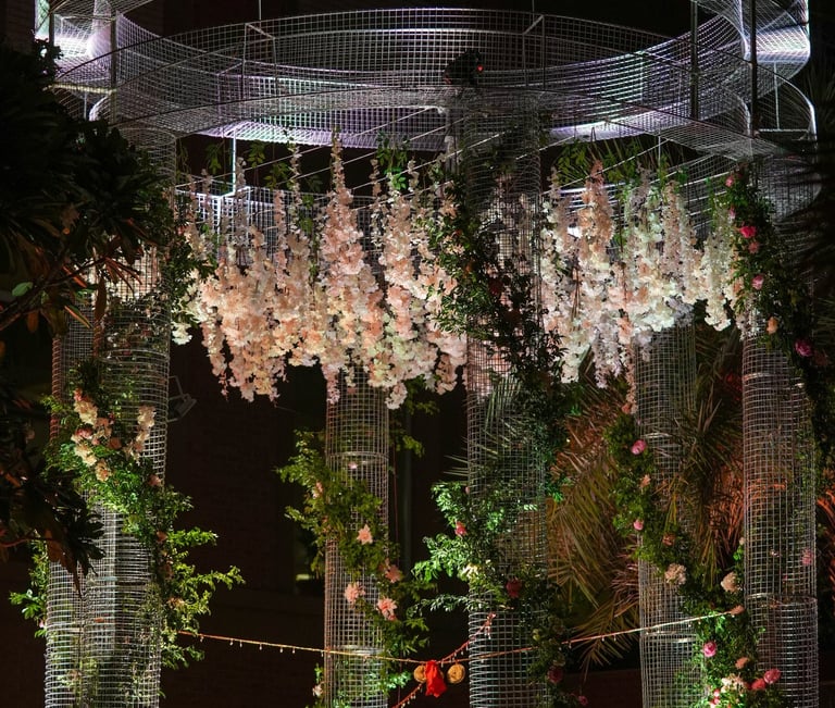 a wedding ceremony with a circular structure with flowers