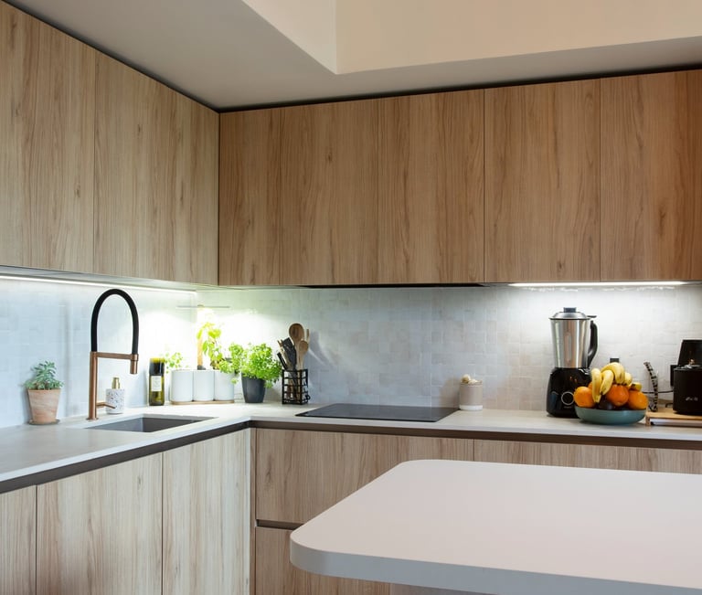 a kitchen with a large light fixture and a wooden floor