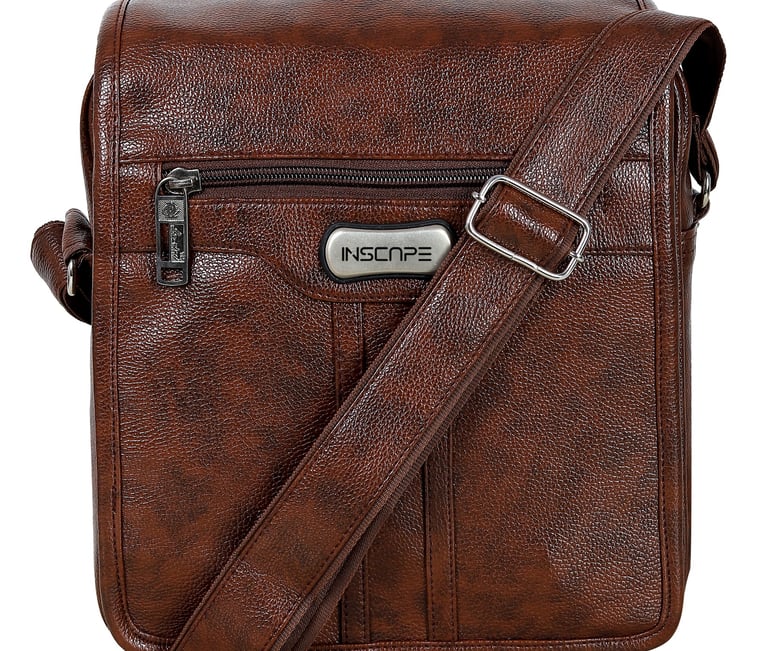 a brown leather sling bag with a silver metal buckle