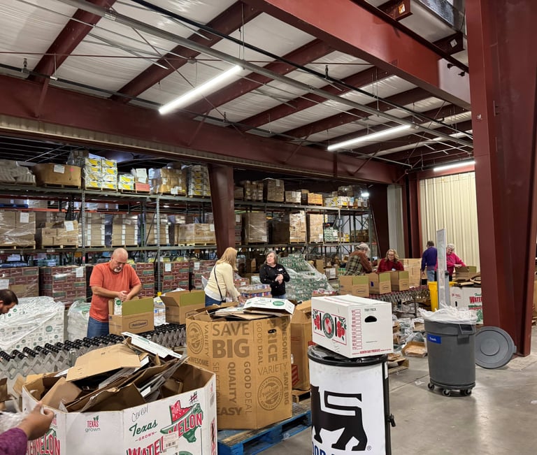 People working on a line at a food distribution center