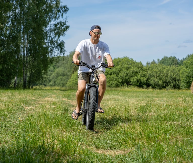 a man riding an electric bicycle in a field