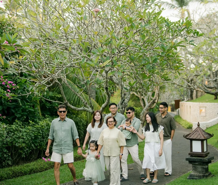 Extended family standing together on a resort garden pathway during a multigenerational family photography session in Bali.
