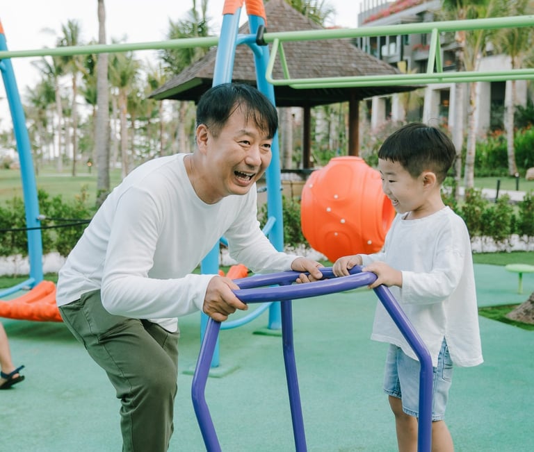 Resort family photography session at The Apurva Kempinski Bali capturing candid family moments at the playground.