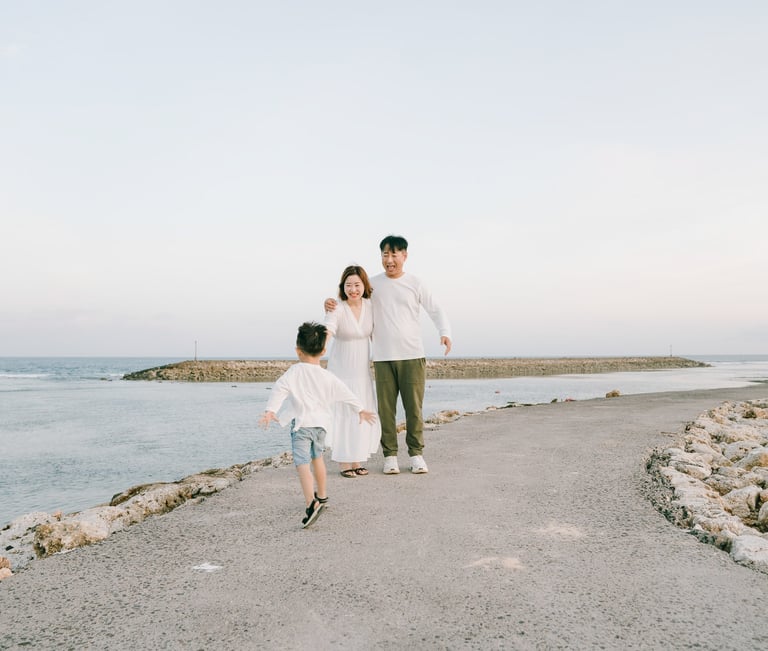 Candid family moment captured during a beach photography session at The Apurva Kempinski Bali.