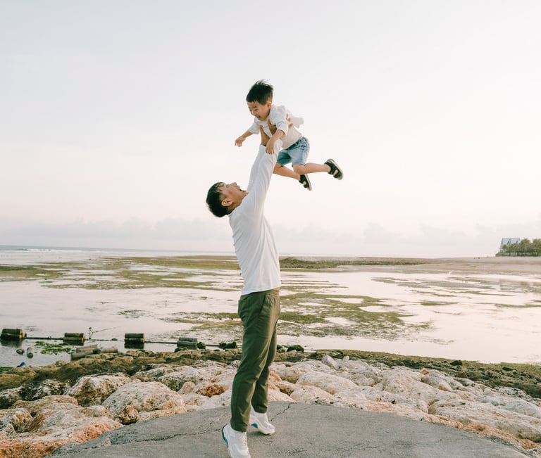 Family portrait on the jetty during a luxury family photography session at The Apurva Kempinski Bali.