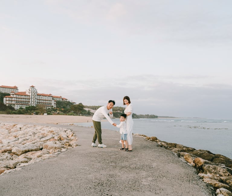 Father and son portrait on the jetty at The Apurva Kempinski Bali beachfront.