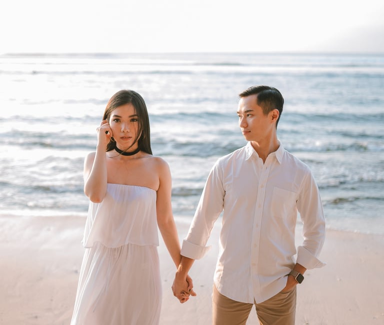 Couple walking on the beach during a proposal photography session at Anantara Uluwatu Bali Resort.