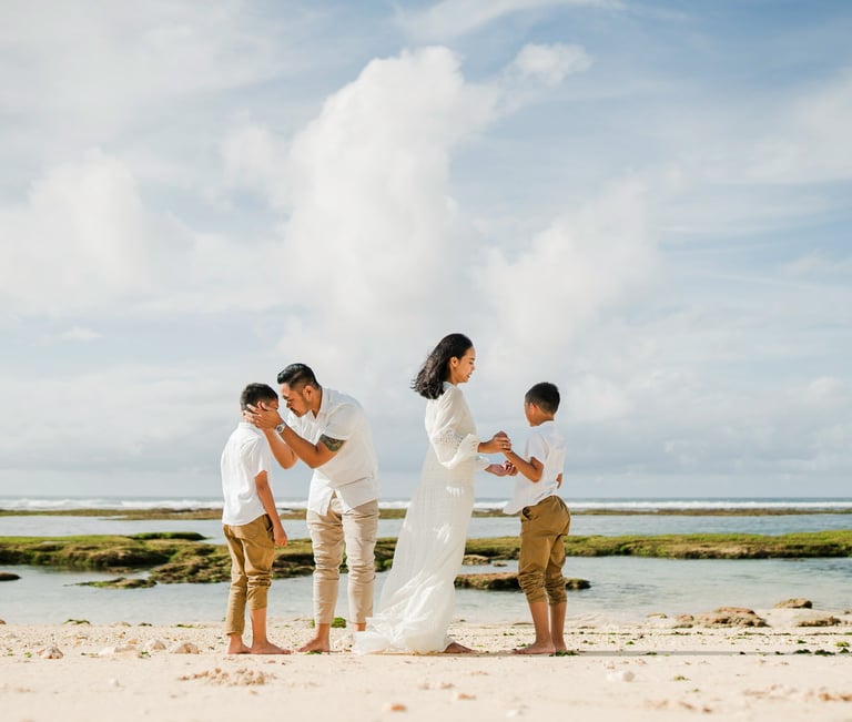 Family beach photography at Melasti Beach Bali, relaxed cinematic family session