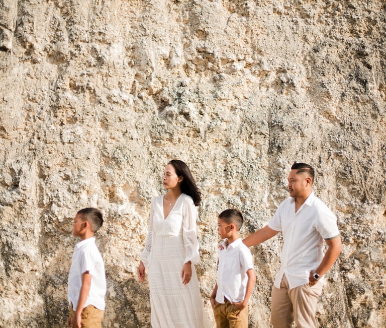 Ayunda family walking through the limestone cliffs road near Melasti Beach Bali.