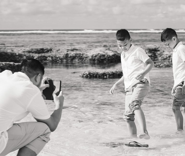Ayunda family sharing a candid moment by the shoreline at Melasti Beach Bali.