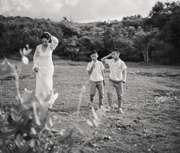 Ayunda family walking playfully together during golden hour at Melasti Beach Bali.