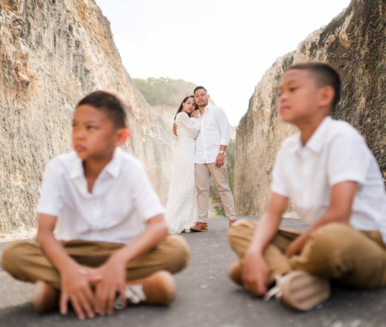 Portrait of Ayunda brothers sitting together during a family photography session at Melasti Beach Bali.