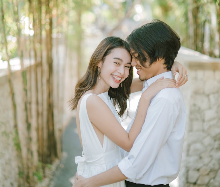 Intimate couple embrace in the garden during a photography session at Novotel Bali Benoa in Tanjung Benoa Bali.