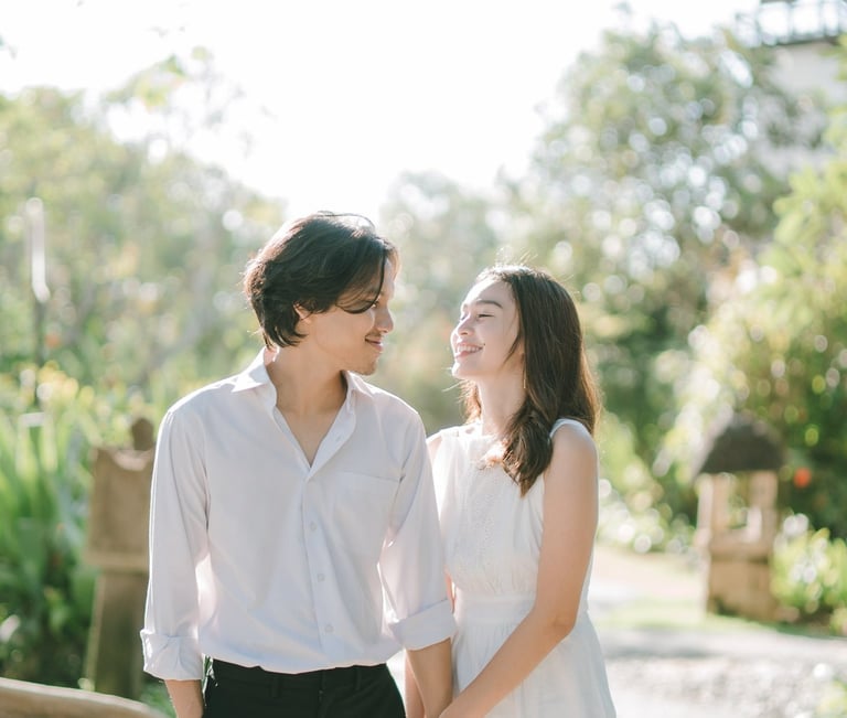 Intimate couple walking along the garden pathway at Novotel Bali Benoa in Tanjung Benoa Bali.