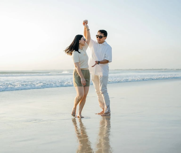 Parents walking together along the shoreline during a family photography session at InterContinental Bali Resort