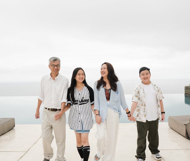 Family walking together at Alila Villas Uluwatu Bali with minimal architecture and soft tones
