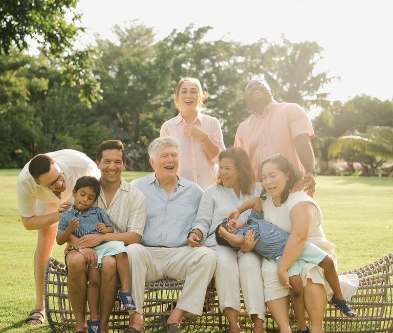 extended family relaxing together on rattan lounge chairs at rimba by ayana bali during family photography