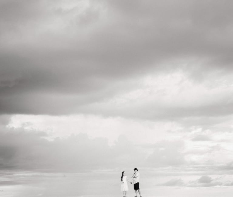 Couple walking along the beach during family photography session at Sofitel Nusa Dua Bali