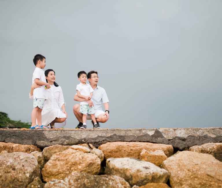 intimate family portrait by the shoreline at Conrad Bali in Nusa Dua