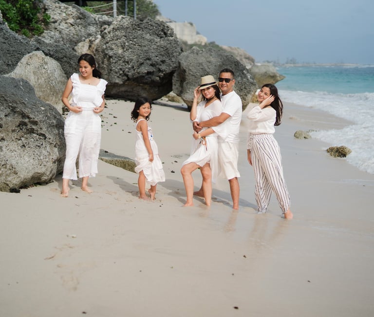 Family standing together along the beach at Karma Kandara Bali  