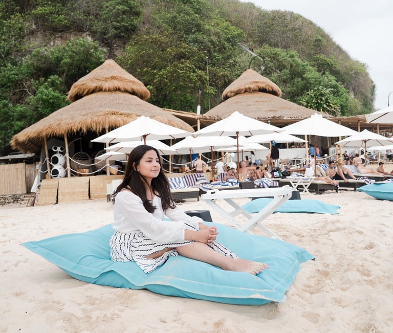 Family relaxing at Karma Kandara Bali resort pool with cliffside ocean view  