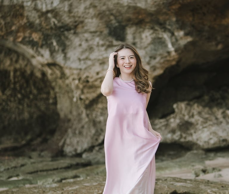 Woman walking along the beach near cliff during photoshoot at Geger Beach Nusa Dua Bali