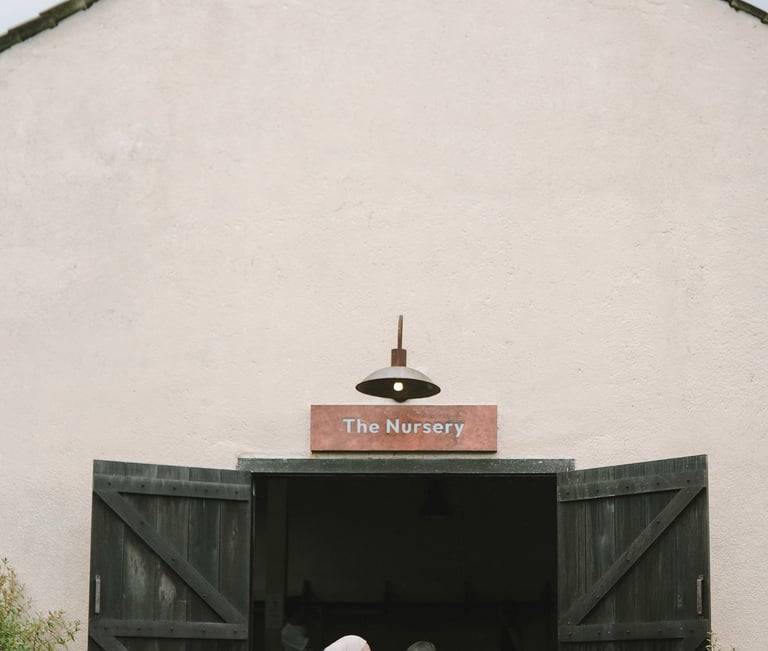 Mother and child in front of nursery house during a family photography session at Bali Farm House Bedugul Bali.