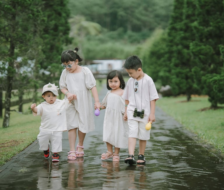 Family walking on wet garden path during a family photography session at Bali Farm House Bedugul Bali.